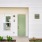 white home with a sage green door and ample windows
