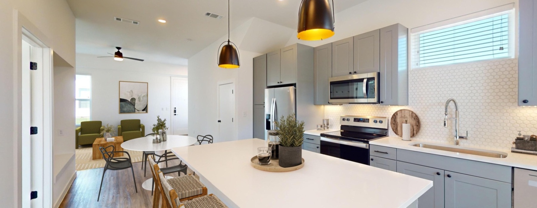 Spacious kitchen with large island and hardwood style flooring 