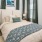 Bedroom with large bed, ensuite. queen bed and nightstands.