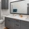 Bath with dual vanity, large mirror and glass enclosed showerA