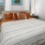 Bedroom with large bed, ensuite. queen bed and nightstands.